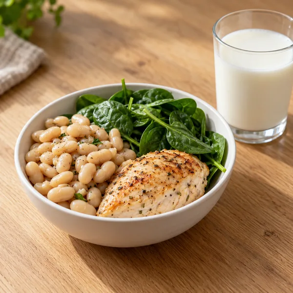 L-glutamine powder in a wooden spoon beside protein-rich foods